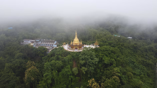 Aerial view of the temple surrounded by hills and forest